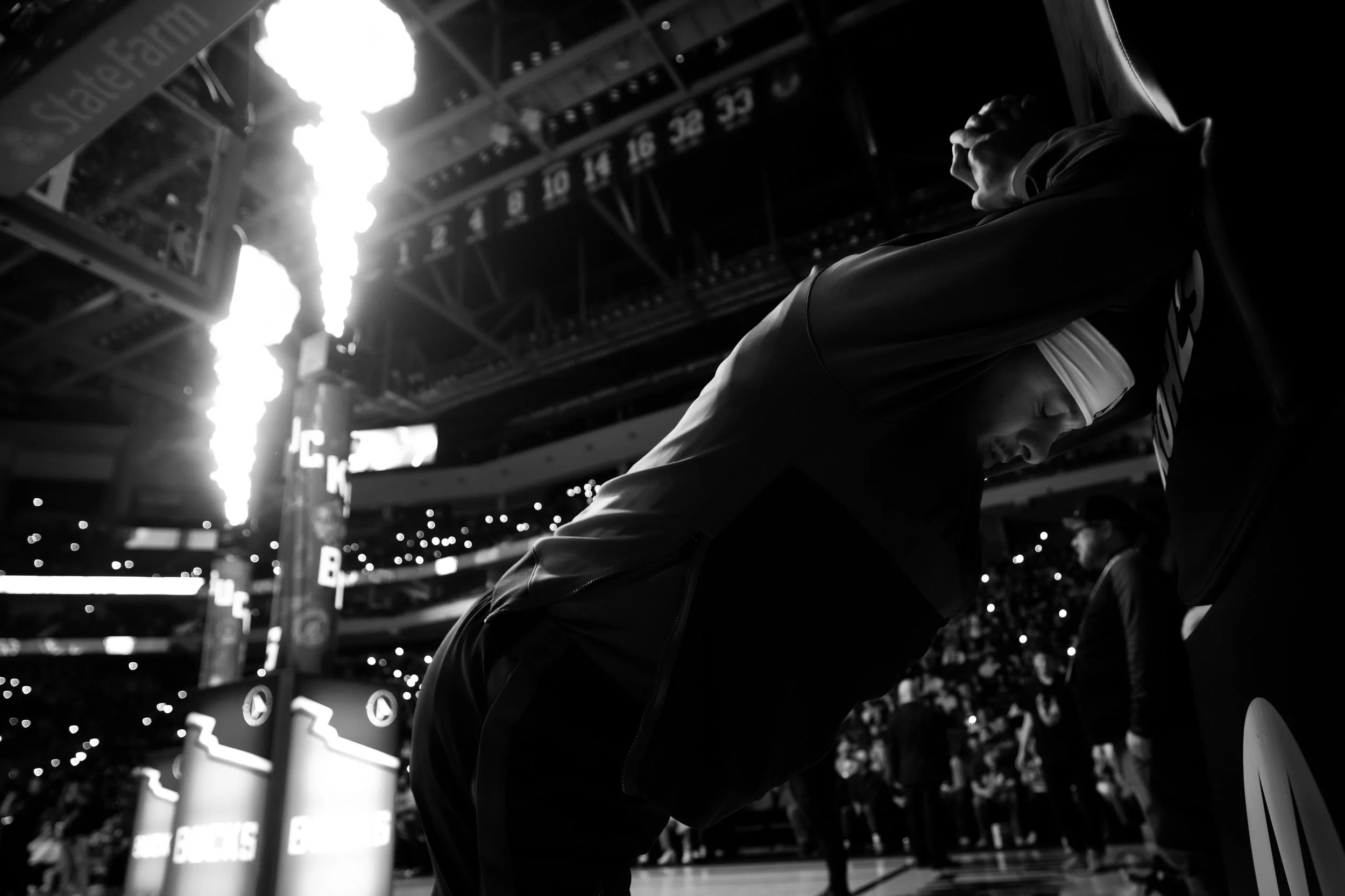 Player stretching at the arena tunnel as pregame flames fire, photographed by Mike Jones